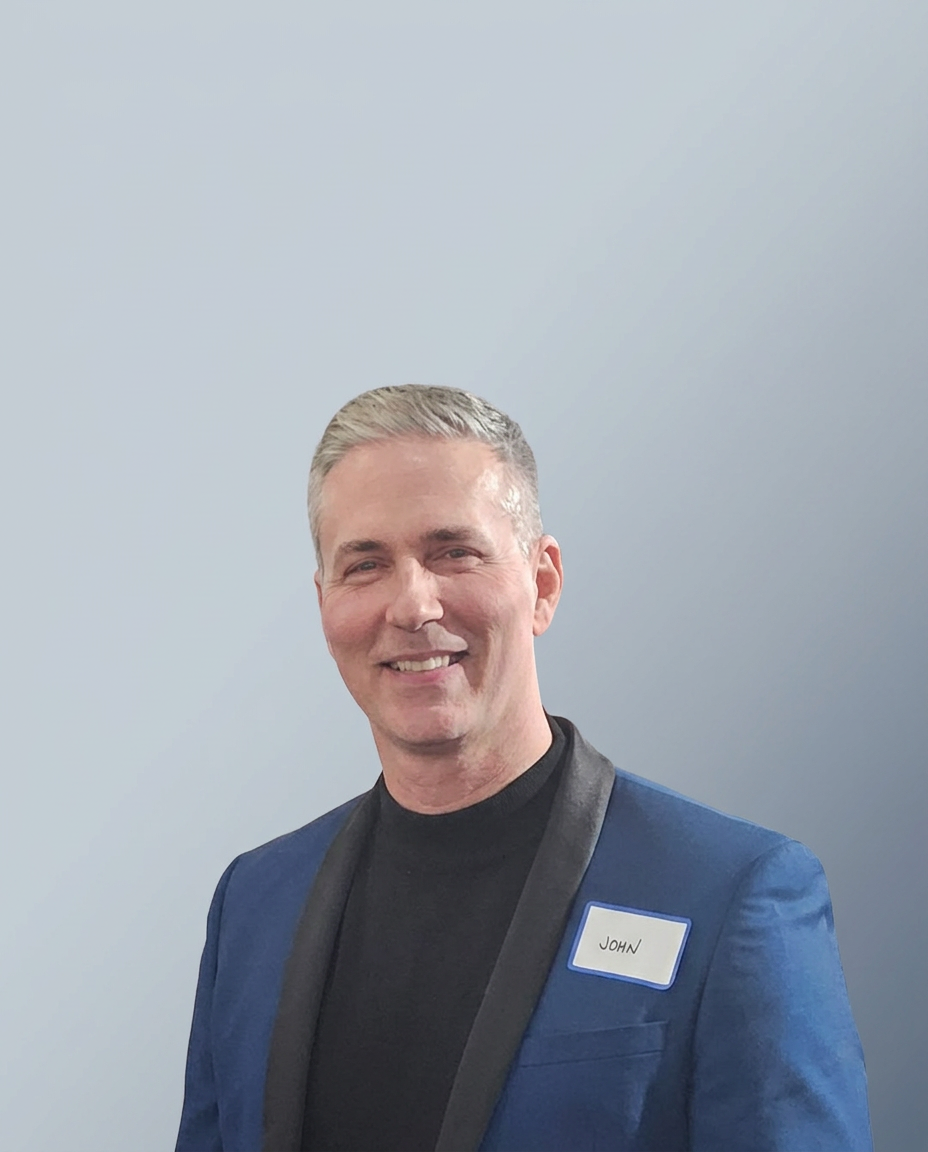 Portrait of John Sinkevicius wearing a blue suit jacket